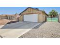 A single-story home featuring an attached garage and desert landscaping offering low maintenance and appealing curb appeal at 1708 Anzio St, Las Vegas, NV 89108