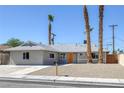 Beautifully landscaped single-story home with a bright orange front door at 2005 Jansen Ave, Las Vegas, NV 89101