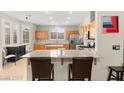 Well-lit kitchen featuring granite countertops, stainless steel appliances, and a central island with seating at 262 Cielito Lindo St, Henderson, NV 89012