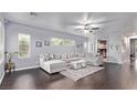 Spacious living room with large sectional sofa, hardwood floors, and plenty of natural light at 3005 Dotted Wren Ave, North Las Vegas, NV 89084