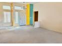 Spacious living room featuring plush carpet flooring, neutral walls, and an entry door with stained glass windows at 3028 Ripon Dr, Las Vegas, NV 89134