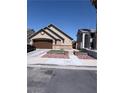 A well-kept single-story home featuring a two-car garage and landscaped front yard at 3078 Kennewick Dr, Las Vegas, NV 89121
