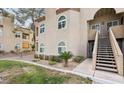 Close-up of a modern condo building showing stairs, neutral colors, and maintained grounds at 3145 E Flamingo Rd # 1045, Las Vegas, NV 89121