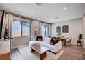 Inviting living room with a comfortable sofa, dining area, and modern decor at 3358 Via Strada St, Henderson, NV 89044