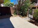 Private backyard boasts a spacious concrete patio, mature trees and gated access to common areas at 4338 Caliente St # 12, Las Vegas, NV 89119