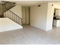 Inviting living room featuring neutral tile floors, staircase access and plenty of natural light at 4338 Caliente St # 12, Las Vegas, NV 89119