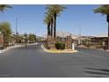 Community gate featuring stone pillars and wrought iron fencing for a secure entrance at 5935 Saddle Horse Ave, Las Vegas, NV 89122