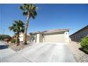 Single-story home with desert landscaping, large driveway, and an attached garage at 6040 Eganridge Ct, North Las Vegas, NV 89081