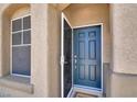 Inviting entryway featuring a blue front door, and a storm door, allowing natural light to fill the space at 636 Pacific Cascades Dr, Henderson, NV 89012