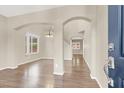 Open-concept living room with beautiful hardwood floors and arched doorways, creating a seamless flow at 636 Pacific Cascades Dr, Henderson, NV 89012