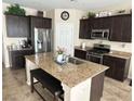 Spacious kitchen with granite countertops, stainless steel appliances, and a convenient center island at 6682 Salt Pond Bay St, Las Vegas, NV 89149
