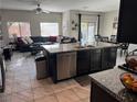 Open-concept living space featuring a spacious seating area, a dining table, and a large kitchen island at 6867 Dragonfly Rock St, Las Vegas, NV 89148