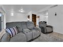 Open-concept living room with tile flooring, comfortable seating, and access to kitchen and backyard at 781 Bourbon St # 1, Pahrump, NV 89048