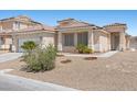 Inviting single-story home boasting desert landscaping, a tile roof, and an attached two-car garage at 820 Peach Ave, North Las Vegas, NV 89032