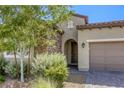 Charming home with stone accents, desert landscaping, and a two-car garage at 832 Gallery Course Dr, Las Vegas, NV 89148