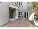 Elegant home exterior featuring a private courtyard with stone accents and architectural details at 9408 Players Canyon Ct, Las Vegas, NV 89144