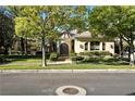 Beautiful single-story home with lush green lawn, manicured hedges, and mature shade trees at 9408 Players Canyon Ct, Las Vegas, NV 89144