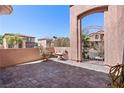 Enclosed patio area with chairs and outdoor seating. Decorative paver flooring at 10478 Beallsville St, Las Vegas, NV 89141