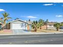 Charming single-story home featuring a well-maintained lawn with mature palm trees and an attached two-car garage at 105 Shadow Ln, Las Vegas, NV 89106