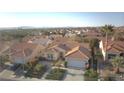 Expansive aerial view of home, featuring a terra cotta roof and lush landscaping at 10717 Grand Cypress Ave, Las Vegas, NV 89134