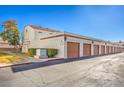 View of the condo garages with a neutral color scheme with well-maintained landscaping and walkway at 1800 Edmond St # 124, Las Vegas, NV 89146