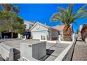 Nice single-story home with a two-car garage, spacious driveway, mature trees, and low-maintenance desert landscaping at 1950 Turtlerock St, Las Vegas, NV 89142