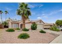 Single-story home featuring desert landscaping, a two-car garage, a driveway with parking, and solar panels at 1981 Spring Lake Dr, Henderson, NV 89002