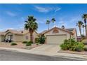 Single-story house with a two-car garage, desert landscaping, and solar panels on the roof at 1981 Spring Lake Dr, Henderson, NV 89002