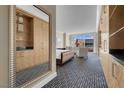 Bedroom featuring a king-size bed, built-in cabinets, and large windows with a cityscape view at 2000 Fashion Show Dr # 2400, Las Vegas, NV 89109
