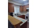 Bright kitchen with white countertops, oak cabinets, stainless steel sink and white appliances at 2243 Aspen Mirror Way # 102, Laughlin, NV 89029