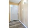 Clean entryway featuring a white front door and modern gray flooring at 2450 Tournament St, Las Vegas, NV 89142