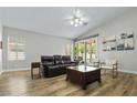 Inviting living room features wood floors, modern furniture, and access to outdoor space at 2512 Huber Heights Dr, Las Vegas, NV 89128