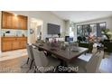 Open dining room with modern lighting, a wet bar, and access to the outdoors at 2723 Seabridge Dr, Las Vegas, NV 89121