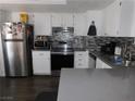Bright kitchen with stainless steel refrigerator and appliances, complemented by white cabinetry at 2921 Country Manor Ln # 139, Las Vegas, NV 89115
