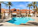 Community pool with lounge chairs and lush landscaping at 3111 Lido Isle Ct, Las Vegas, NV 89117