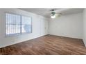 A light-filled bedroom featuring laminate flooring and a double-door closet at 3164 Richford Pl, Las Vegas, NV 89102