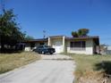 Single-story home with a flat roof, small front porch, and driveway at 3175 Palmdale St, Las Vegas, NV 89121
