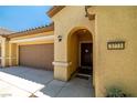 Close-up of a home's entrance, showcasing a well-maintained facade and a convenient two-car garage at 3773 Blake Canyon Dr, North Las Vegas, NV 89032