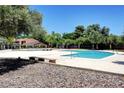 A pristine community pool area with clear blue water and comfortable seating for residents to enjoy at 4036 Nightingale Ct, Las Vegas, NV 89107