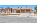 Single-story home with desert landscaping, a two-car garage, and a quaint, welcoming entrance at 4784 El Escorial Dr, Las Vegas, NV 89121