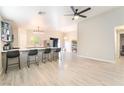 Inviting living space featuring an open floor plan, wood floors, neutral walls, and modern lighting at 5009 Peaceful Pond Ave, Las Vegas, NV 89131