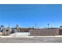 Exterior shot of the home showcasing its facade, driveway, and fenced yard at 5093 Sun Valley Dr, Las Vegas, NV 89122
