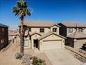 Two-story home with desert landscaping, large driveway, tile roof and attached two-car garage at 5308 Hollyridge St, North Las Vegas, NV 89081