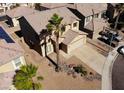 Two-story home featuring a spacious driveway, desert landscaping and attached two-car garage at 5308 Hollyridge St, North Las Vegas, NV 89081