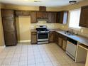 Traditional kitchen with wood cabinets and stainless steel appliances at 608 Watkins Dr, Las Vegas, NV 89107
