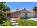 Attractive home featuring a well-maintained lawn, ample parking, and a charming front porch area at 6307 Dusty Mile Ct, North Las Vegas, NV 89031