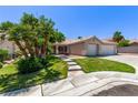 Beautiful home with mature trees, green lawn, and spacious three-car garage, perfect for families and entertaining at 6307 Dusty Mile Ct, North Las Vegas, NV 89031