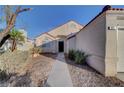 Inviting front exterior with a walkway leading to the front door and desert landscaping at 641 Bay Bridge Dr, North Las Vegas, NV 89032