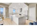 Open kitchen with large island, stainless steel appliances, and modern white cabinetry overlooking city views at 8255 Las Vegas Blvd # 1422, Las Vegas, NV 89123