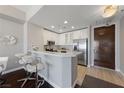 Modern kitchen with white cabinetry, stainless steel appliances, breakfast bar, and modern fixtures at 8255 Las Vegas Blvd # 809, Las Vegas, NV 89123